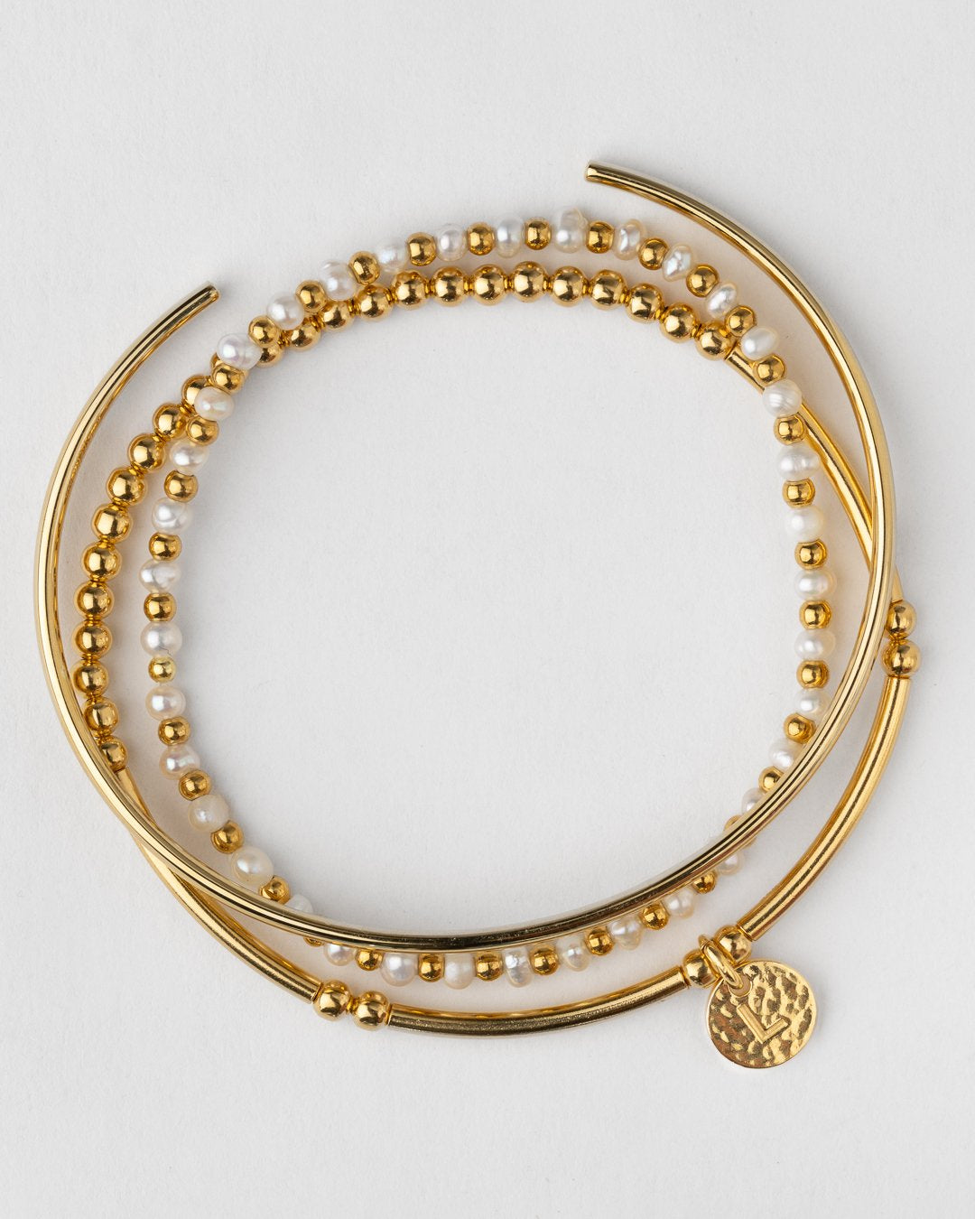 Layered 14k gold plated bracelet stack with cuff, pearl stretch bracelet and bead bracelet